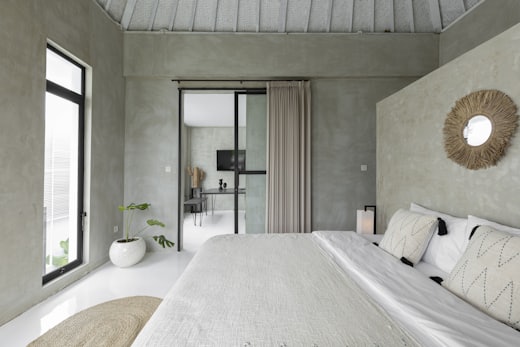 Guest room with morning light through a glass door
